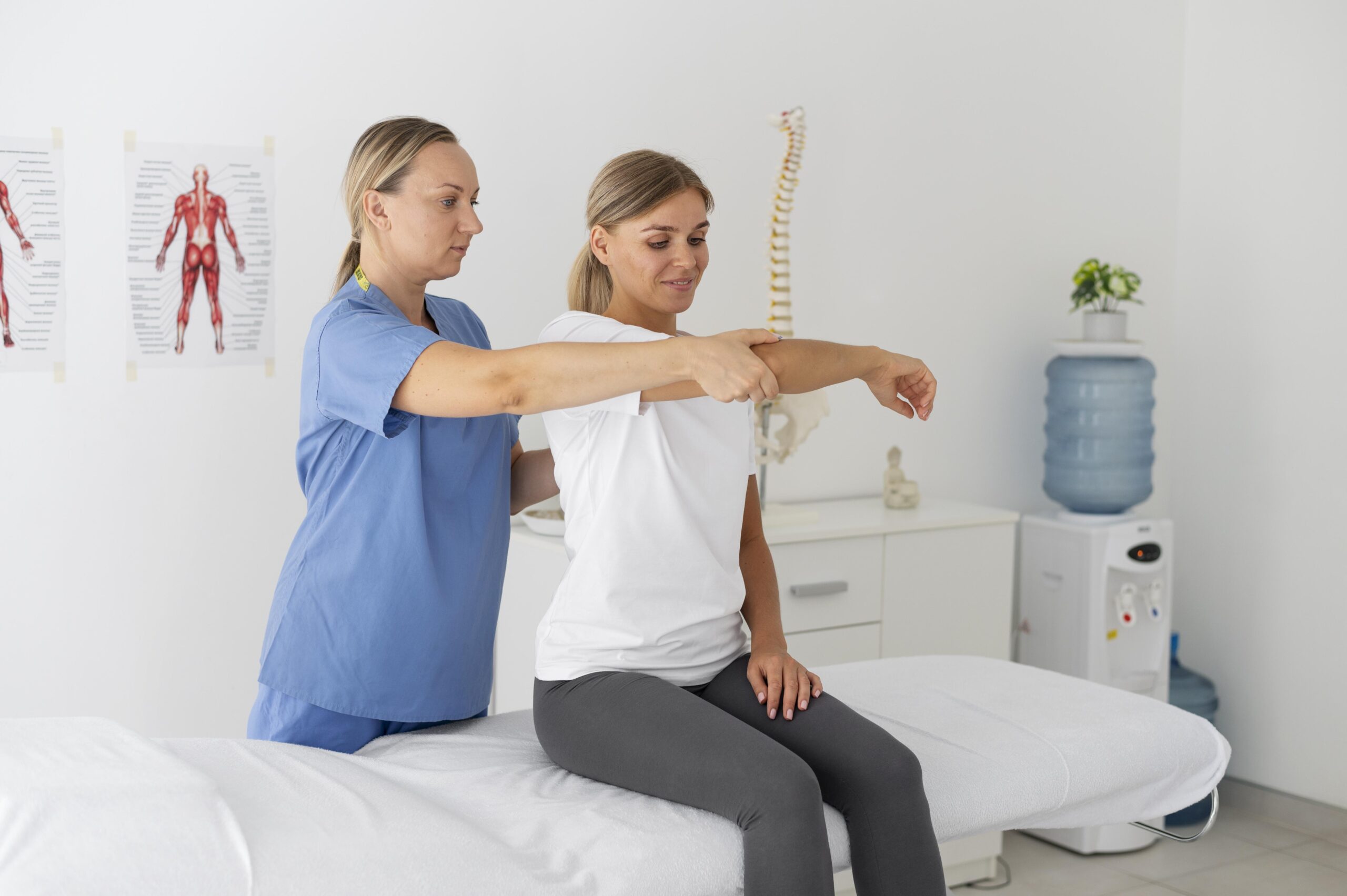 physiotherapist-helping-female-patient-her-clinic